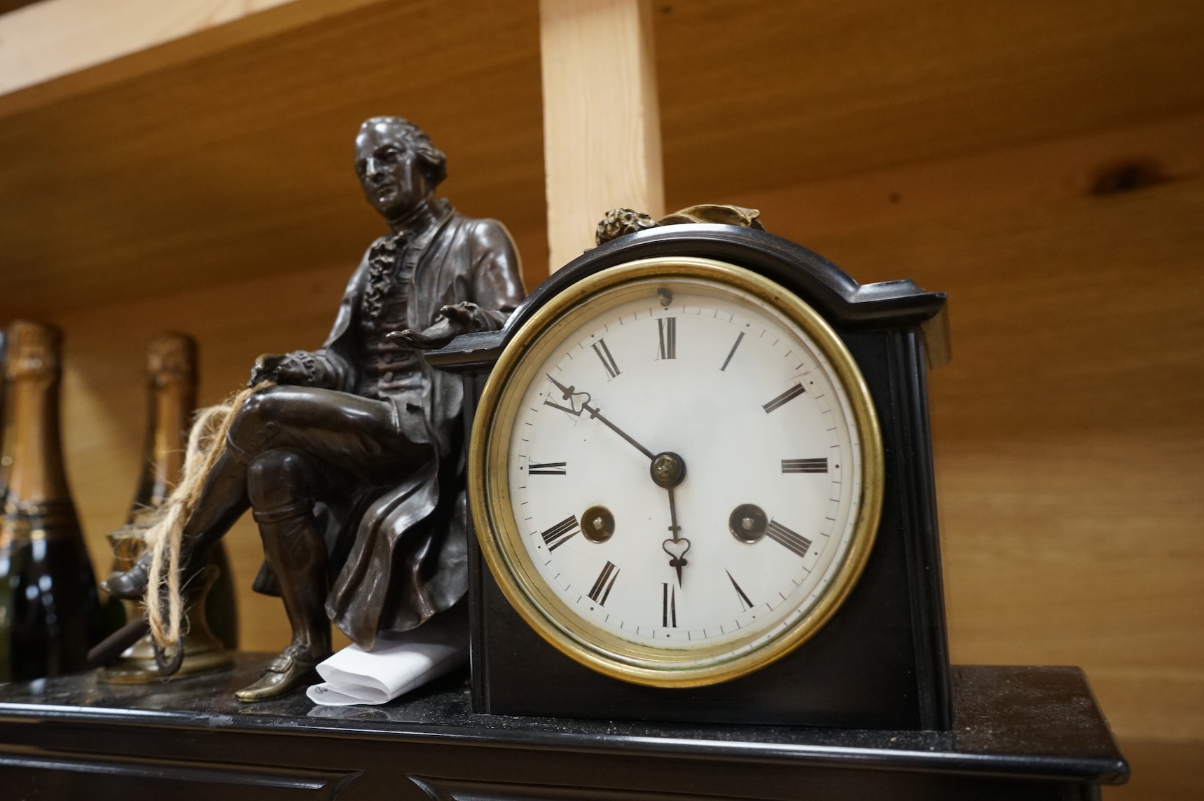 A 19th century French bronze and slate 8 day mantel clock, mounted with figure of Denis Diderot (1713-1784), 40cm wide